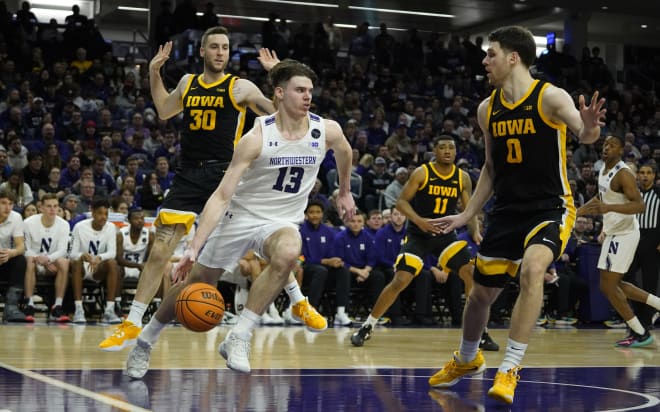 Brooks Barnhizer drives through Iowa's defense in Northwestern's 80-60 win over Iowa on Sunday. 