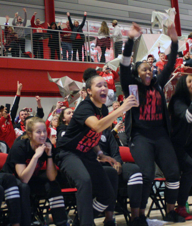 Seniors Ashley Williams (sitting on left) and Miah Spencer (middle with phone) celebrated with fans after NC State was announced on the selection show.