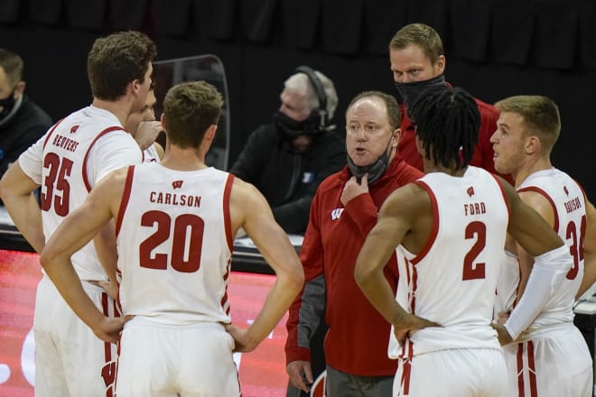 Wisconsin head coach Greg Gard talks to his players during the Badgers vs. Green Bay game