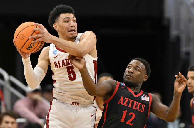 Alabama Crimson Tide guard Jahvon Quinerly (5) looks to pass against San Diego State Aztecs guard Darrion Trammell (12) during the first half of the NCAA tournament round of sixteen at KFC YUM! Center. Photo |  Jamie Rhodes-USA TODAY Sports