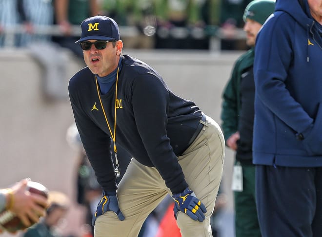 Michigan head coach Jim Harbaugh is seeing changes on his offense, and may recruit to them..