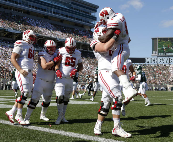 Wisconsin's Corey Clement, right, celebrates his touchdown against Michigan State with his offensive line during the third quarter of the Badgers' blowout win.