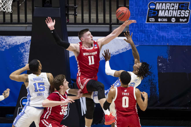 Wisconsin's Micah Potter (11) blocks a shot by North Carolina's Caleb Love (2) during the first half of the Badgers' victory over the Tar Heels.