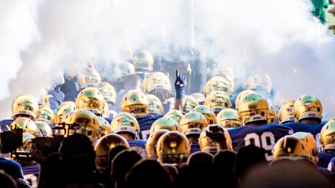 The Notre Dame Fighting Irish football team running onto the field before a game