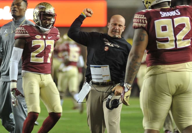Defensive coordinator Charles Kelly celebrates a stop by the defense.