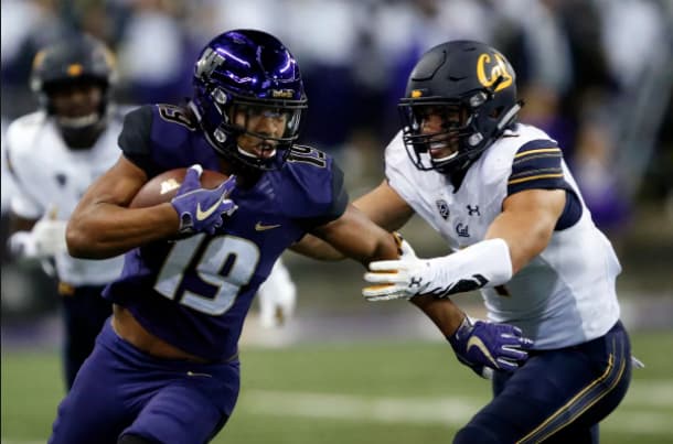 Washington Huskies tight end Hunter Bryant (19) pushes past California Golden Bears linebacker Devante Downs (1) during the second half at Husky Stadium. Photo Credit: Jennifer Buchanan-USA TODAY Sports