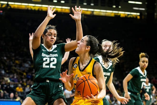 Iowa guard Caitlin Clark, right, drives to the basket as Michigan State guard Moira Joiner (22) defends during a NCAA Big Ten Conference women's basketball game, Sunday, Dec. 5, 2021, at Carver-Hawkeye Arena in Iowa City, Iowa. 