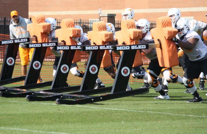 Offensive line working the sled