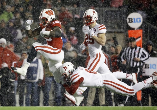 Wisconsin's Melvin Gordon breaks away from Nebraska's Corey Cooper for a 26-yard touchdown in the third quarter of an NCAA college football game, Saturday, Nov. 15, 2014, in Madison, Wis. Gordon ran for 408 yards through three quarters, capping it off with this run to break the single-game major college football rushing record set.