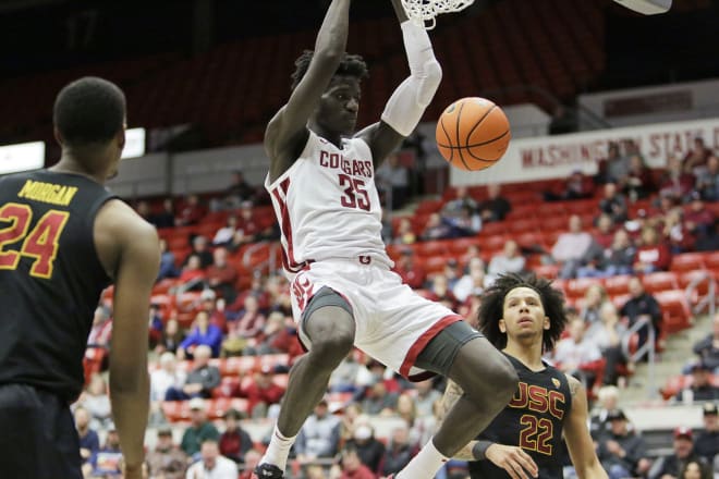 Mouhamed Gueye throws down a dunk in the Cougars' win over USC on Jan. 1.