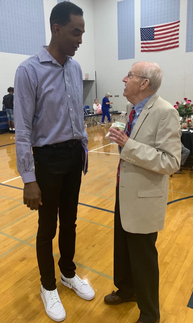 Paul Hatcher (right) talks with former UVA All-American and NBA All-Star Ralph Sampson during the dedication of the Roger Bergey Gymnasium at Harrisonburg High School in 2019.