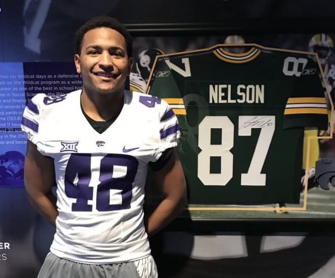 Quinton Hicks on K-State visit in front of Jordy Nelson's pro jersey.