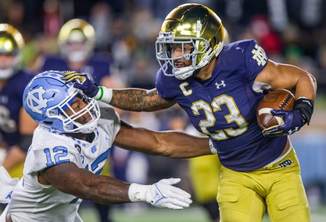 Notre Dame running back Kyren Williams stiff-arms a North Carolina defender on his way to a 91-yard TD run, Oct. 30, against the Tar Heels.