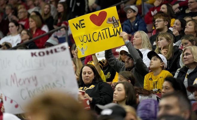 Spectators show their support for Iowa guard Caitlin Clark during the first half of their game against Wisconsin Sunday, December 10, 2023 at the Kohl Center in Madison, Wisconsin. Clark made history Wednesday night against Iowa State when she became the first player in either NCAA men's or women's basketball to get at least 3,000 points, 750 rebounds and 750 assists in a career.