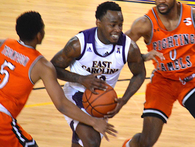 ECU's Tremont Robinson-White drives on Campbell's Trey Spencer and Messiah Thompson in Saturday's game in Greenville. 