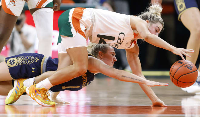 Notre Dame guard Dara Mabrey and Miami guard Haley Cavinder fight for a loose ball during the second half  of Thursday night's Irish road win.