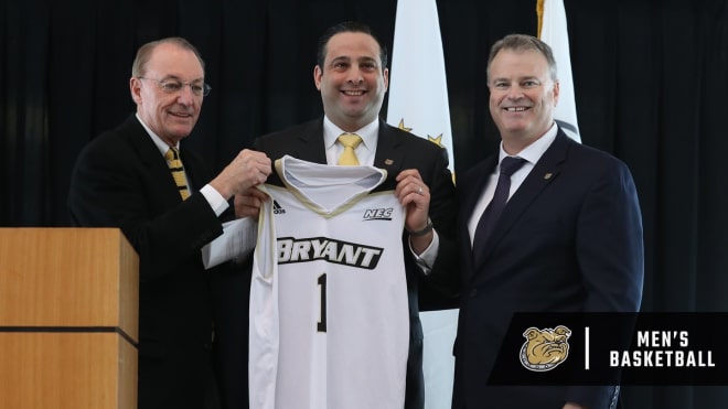 Bryant University's new head coach Jared Grasso (center)