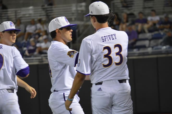Jake Agnos is congratulated after coming out of the game in the ninth inning of ECU's game one win over UConn.