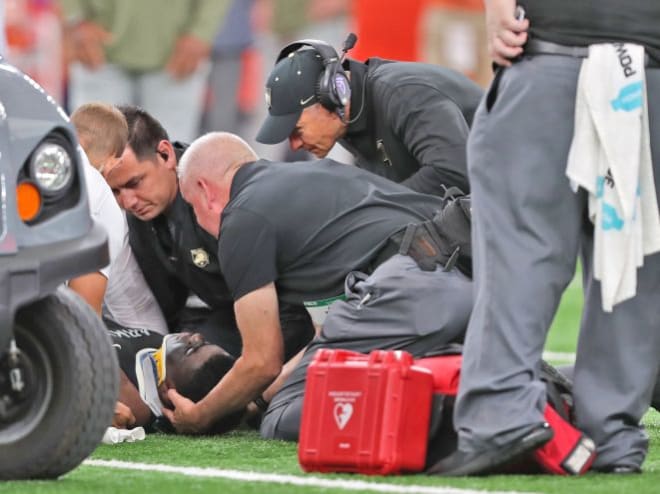 Army West Point Medical Staff to attend Andre Miller as head coach Jeff Monken looks on