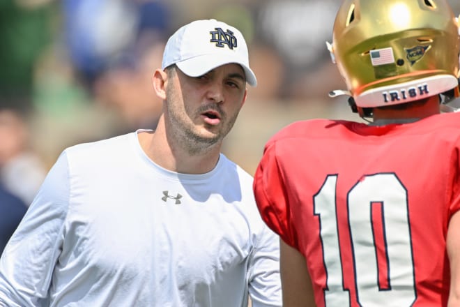 Notre Dame Fighting Irish offensive coordinator Tommy Rees talks to quarterback Drew Pyne (10) during warmups before the Blue-Gold Game at Notre Dame Stadium. Photo | Matt Cashore-USA TODAY Sports