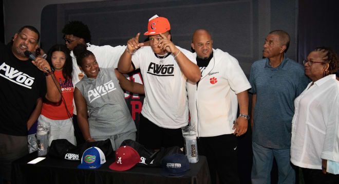 Woods is shown here celebrating with his family after publicly casting his lot with Clemson.