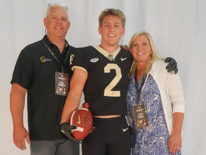 Carney poses with his parents during his visit to Wake on Tuesday