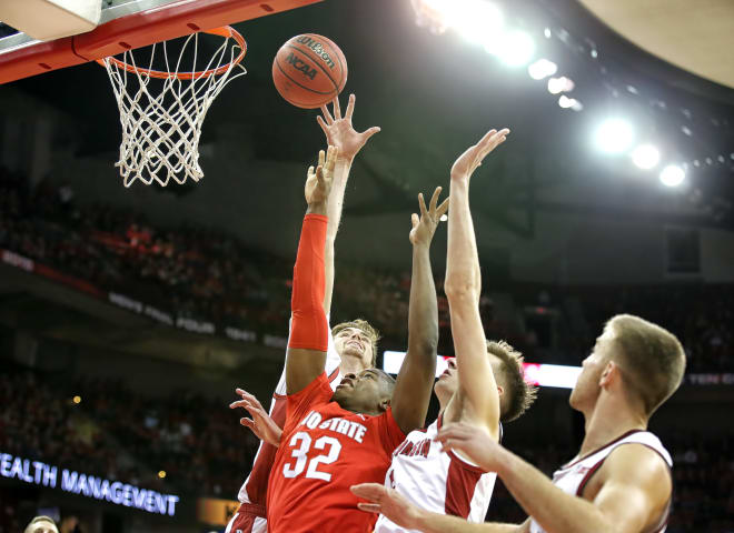 Nate Reuvers (background) and company swarm Ohio State's EJ Liddell during the Badgers' 70-57 victory Feb.9.