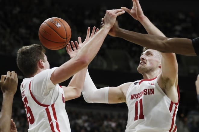 Wisconsin forwards Nate Reuvers (35) and Micah Potter (11) reach for a rebound against Michigan State. Neither player had a rebound against Michigan.