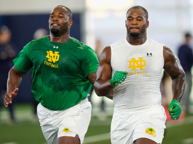 Defensive linemen Jayson Ademilola, left, and twin brother Justin Ademilola run a drill during Notre Dame's Pro Day.