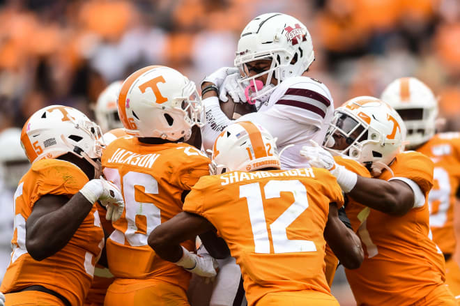 Oct 12, 2019; Knoxville, TN, USA; Tennessee Volunteers defensive back Shawn Shamburger (12) and defensive back Terrell Bailey (36) and defensive back Shawn Shamburger (12) and linebacker Daniel Bituli (35) and others gang tackle Mississippi State Bulldogs wide receiver Osirus Mitchell (5) in the fourth quarter at Neyland Stadium.