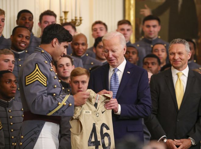 Army Fotball Captain and current New York Jets Jimmy Ciarlo presents President Biden with Honorary Army football jersey