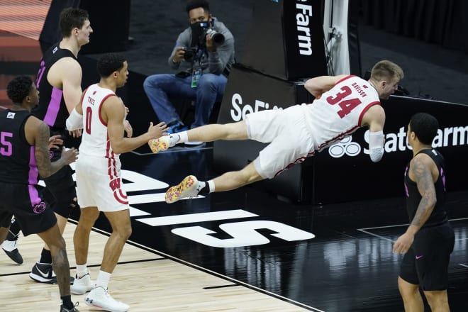 Wisconsin's Brad Davison (34) calls timeout after diving for a loose ball during the second half of an NCAA college basketball game against Penn State at the Big Ten tournament. Wisconsin won 75-74.