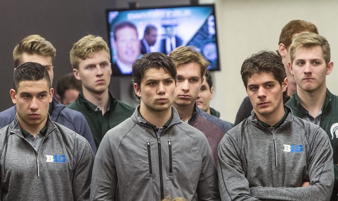 Members of Michigan State's hockey team, including former USA NTDP player Patrick Khodorenko (in the maroon, middle), watch Danton Cole's introductory press conference, Tuesday at Munn Ice Arena.