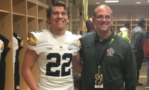 Samson Evans with his father, Matt, at Iowa's junior day on Sunday.