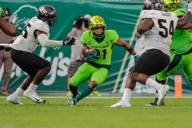 Nov 27, 2020; Tampa, Florida; South Florida Bulls running back Brian Battie (21) runs the ball against the UCF Knights at Raymond James Stadium.