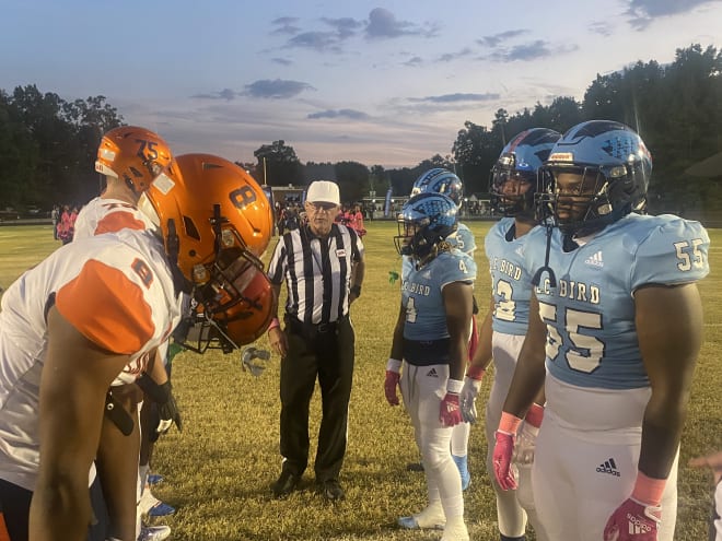 Captains from Manchester and L.C. Bird meet at midfield prior to the start of Friday night's contest