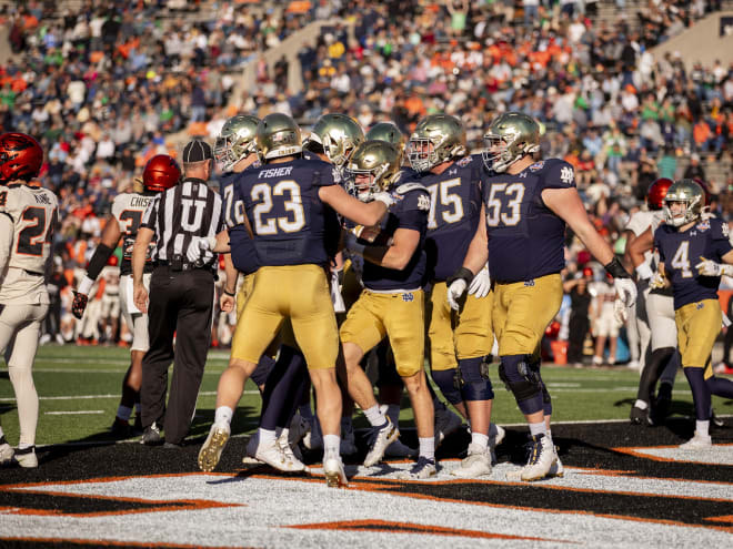 Walk-on running back Chase Ketterer, middle, celebrates with teammates after scoring Notre Dame's final touchdown in a 40-8 Sun Bowl victory over Oregon State.
