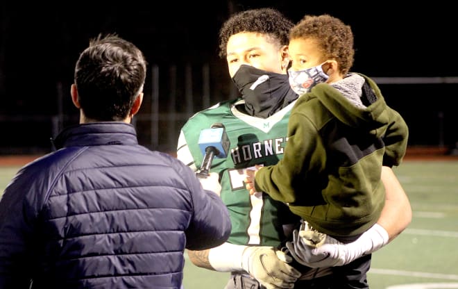 New England defensive lineman TJ Guy signed with Michigan Wolverines football recruiting, Jim Harbaugh.