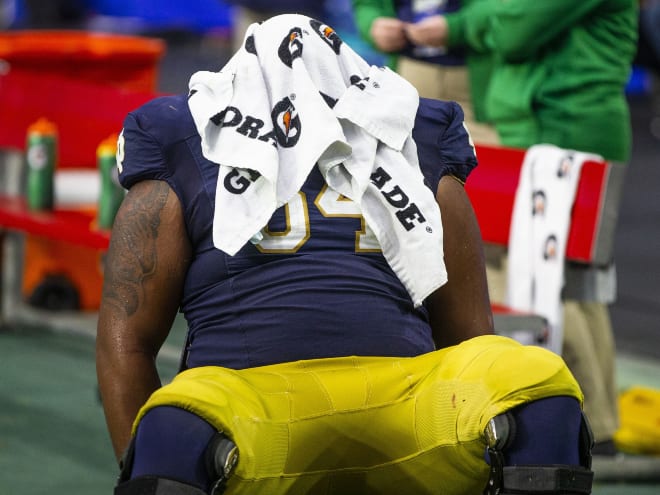 Offensive tackle Blake Fisher sits with a towel on his head in the fourth quarter of Notre Dame's 37-35 loss to Oklahoma State in the Fiesta Bowl.