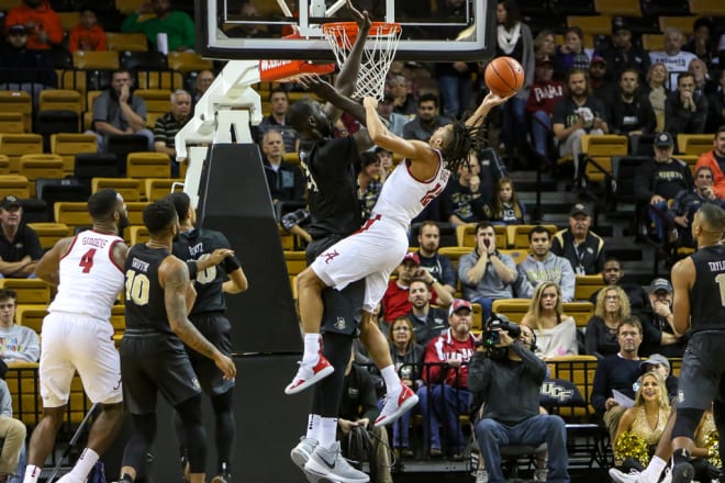 Tacko Fall defends Dazon Ingram during UCF's 70-64 victory against Alabama last season. 