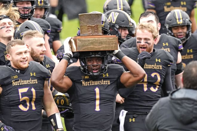 Jesse Brown holds up The Hat after Northwestern beat Illinois.