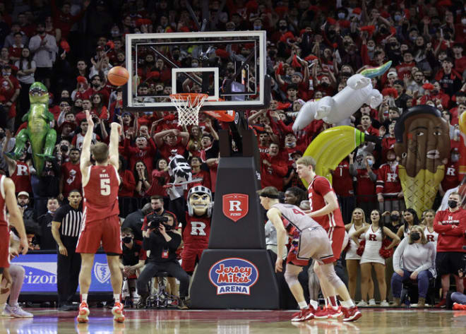 Rutgers students wave inflatables as Wisconsin forward Tyler Wahl (5) attempts a free throw during a 2022 road game.