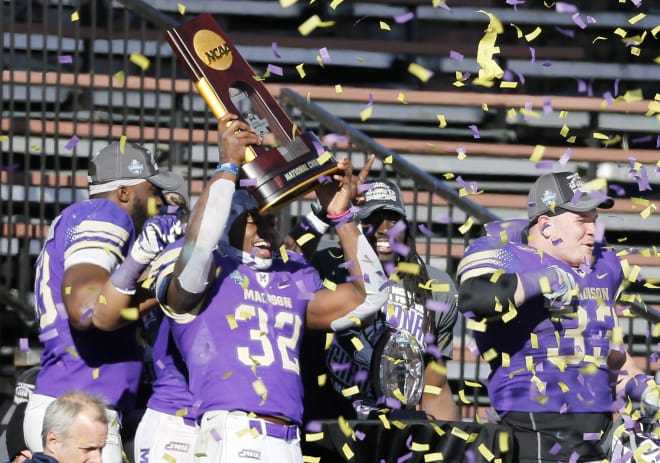 James Madison running back Khalid Abdullah holds the FCS national championship trophy after the Dukes beat Youngstown State 28-14 last week in Frisco, Texas.