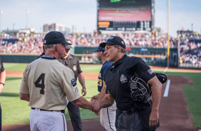 Tim Corbin greets an umpire at the 2019 College World Series.