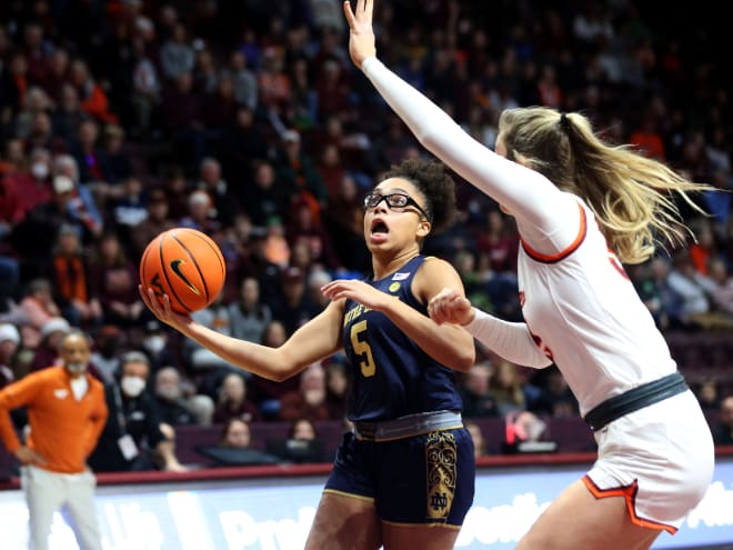 Guard Olivia Miles, left, helped Notre Dame close out a win at Virginia Tech with 16 points, 13 rebounds and seven assists.