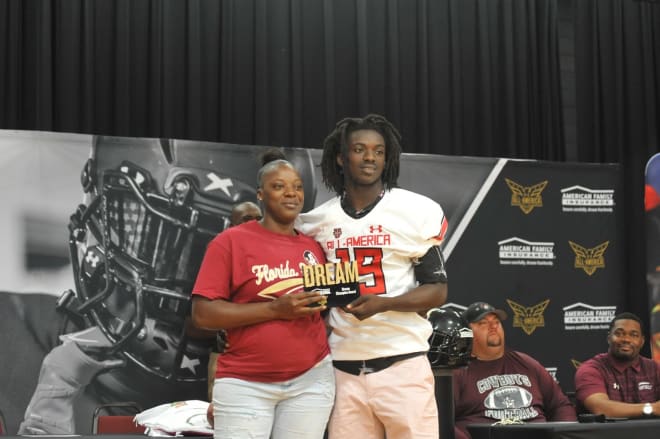 FSU DB commit Travis Jay poses with his mother after his Under Armour All-America presentation.