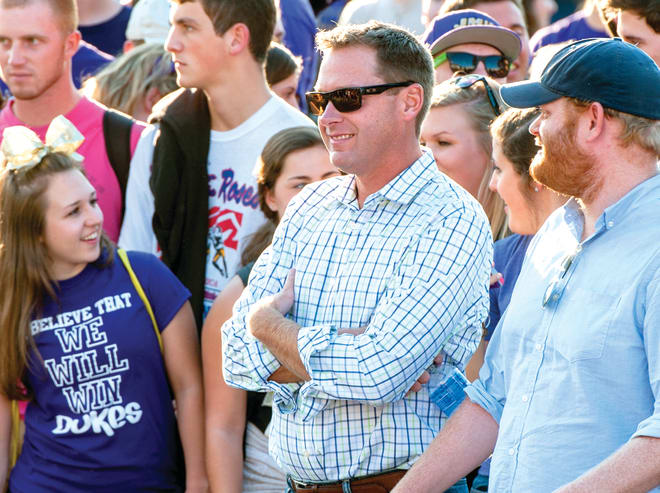 JMU grad Lee Fitting (center), now vice president of college sports at ESPN, watches the 2015 'College GameDay' show at James Madison University in Harrisonburg.