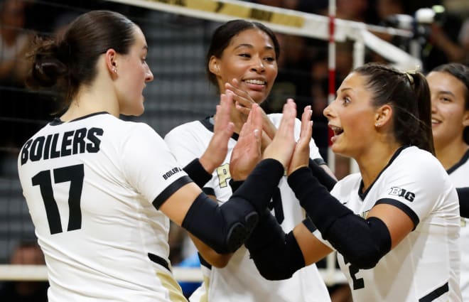 Purdue Boilermakers Evan Hudson (17) and Purdue Boilermakers Chloe Chicoine (2) high-five during the NCAA women s volleyball match against the Central Florida Knights, Thursday, Sept. 14, 2023, at Holloway Gymnasium in West Lafayette, Ind.