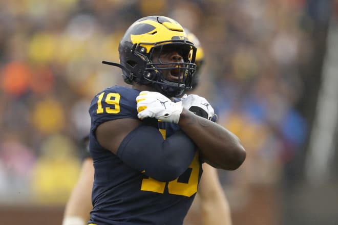 Michigan Wolverines football's Kwity Paye celebrates a sack at Michigan Stadium in 2019.