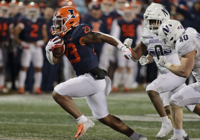 Nov 27, 2021; Champaign, Illinois, USA; Illinois Fighting Illini running back Reggie Love III (23) runs with the ball against the Northwestern Wildcats during the second half at Memorial Stadium. Mandatory Credit: Ron Johnson-USA TODAY Sports